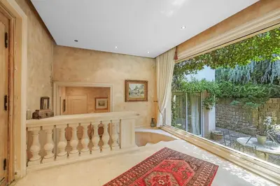 a living room with a staircase and a large window at REF 1849 - Cannes - Villa Provencal Style to rent in Le Cannet