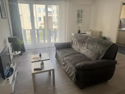 a living room with a couch and a coffee table at Appartement cosy in Cannes