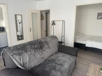 a living room with a couch and a bed at Appartement cosy in Cannes