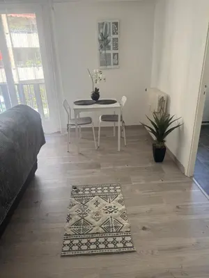 a bedroom with a table and a table and chairs at Appartement cosy in Cannes
