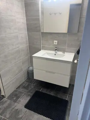 a bathroom with a white sink and a mirror at Appartement cosy in Cannes