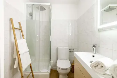 a bathroom with a toilet and a shower and a sink at LE PETIT PALAIS avec mezzanine de charme au cœur de Cannes in Cannes