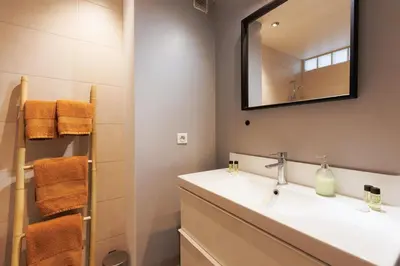 a bathroom with a sink and a mirror at Appartement lumineux Cannes proche mer in Cannes