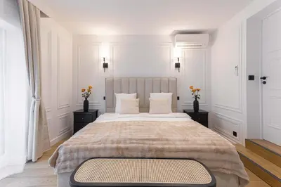 a white bedroom with a large bed with two night stands at Gatsby Chic & Elegance & Billiards & Fitness & Luxury in Cannes