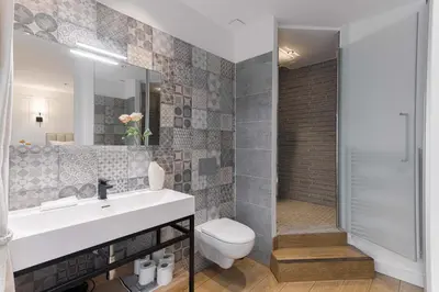 a bathroom with a sink and a toilet and a mirror at Gatsby Chic & Elegance & Billiards & Fitness & Luxury in Cannes