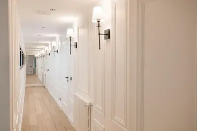 a hallway with white walls and a hallway with lights at Gatsby Chic & Elegance & Billiards & Fitness & Luxury in Cannes