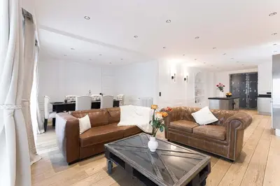 a living room with two leather couches and a table at Gatsby Chic & Elegance & Billiards & Fitness & Luxury in Cannes