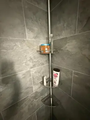 a bathroom with a shower with two shelves on the wall at St Paul Cannes in Cannes