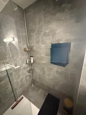 a bathroom with a shower with a blue towel at St Paul Cannes in Cannes