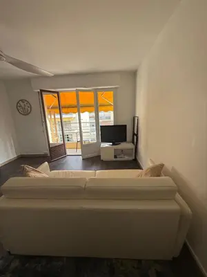 a living room with a large bed and a tv at St Paul Cannes in Cannes