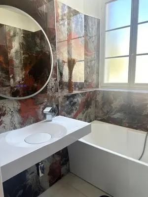 a bathroom with a sink and a tub and a mirror at Villa carré des musiciens in Cannes