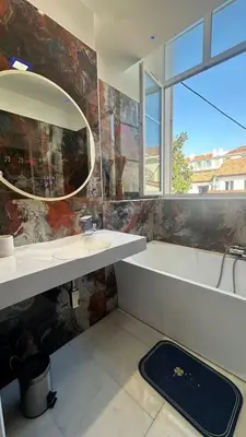 a bathroom with a sink and a mirror at Villa carré des musiciens in Cannes