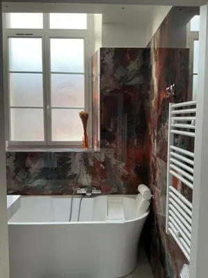 a white bath tub in a bathroom with a window at Villa carré des musiciens in Cannes