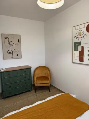 a bedroom with a green dresser and a chair at Kazanou in Cannes
