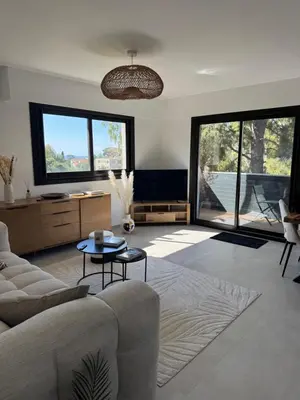 a living room with a couch and a tv at Kazanou in Cannes