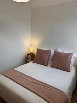 a bedroom with a large white bed with two pillows at Kazanou in Cannes