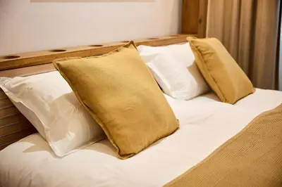 a bed with two pillows on top of it at Alma Apart Residence in Cannes
