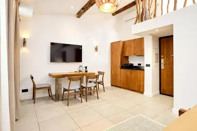 a kitchen and dining room with a table and chairs at Alma Apart Residence in Cannes
