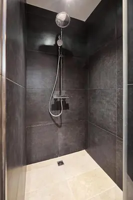 a shower with a shower head in a bathroom at Alma Apart Residence in Cannes