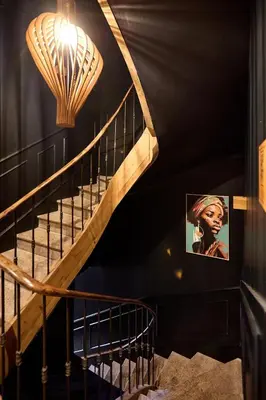 a spiral staircase with a light and a picture on the wall at Alma Apart Residence in Cannes