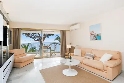 a living room with a couch and a table at Fettolina YourHostHelper in Cannes
