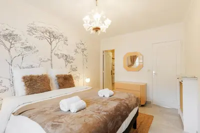 a bedroom with a large bed with towels on it at Fettolina YourHostHelper in Cannes