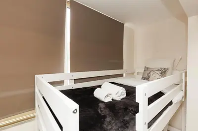 a white bunk bed in a white room at Fettolina YourHostHelper in Cannes