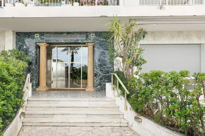 a staircase leading up to a building with a door at Fettolina YourHostHelper in Cannes