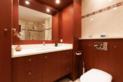 a bathroom with a toilet and a sink and a mirror at Fettolina YourHostHelper in Cannes