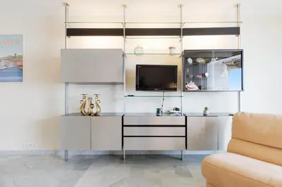 a living room with a tv and a couch at Fettolina YourHostHelper in Cannes