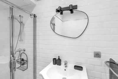 a bathroom with a sink and a mirror and a shower at Croisette 65 apartment-Miramar residence in Cannes