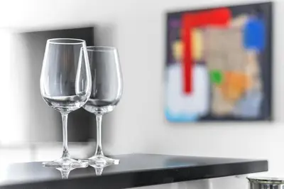 two wine glasses sitting on top of a counter at Croisette 65 apartment-Miramar residence in Cannes