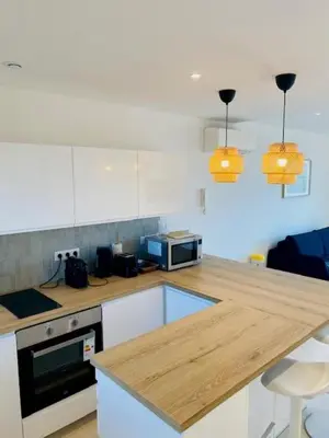 a kitchen with a wooden counter top and a counter top at Cannes Palm Beach - Brand New Studio - Oasis of Calm in Cannes