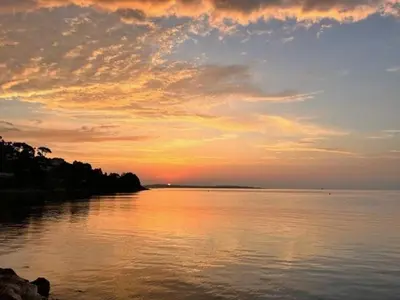 a sunset over a large body of water at Cannes Palm Beach - Brand New Studio - Oasis of Calm in Cannes
