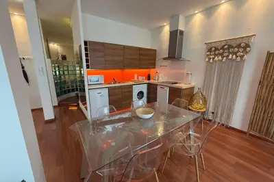 a kitchen with a table and chairs in a room at REF 1988 -Charming apartment in the center of Cannes in Cannes