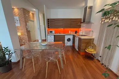 a kitchen with a table and chairs in a room at REF 1988 -Charming apartment in the center of Cannes in Cannes