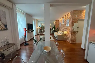 a living room with a glass table and a brick wall at REF 1988 -Charming apartment in the center of Cannes in Cannes