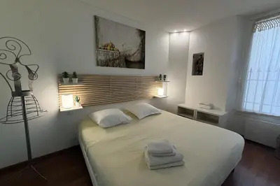 a bedroom with a large bed with two towels on it at REF 1988 -Charming apartment in the center of Cannes in Cannes