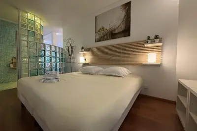 a bedroom with a large white bed and a window at REF 1988 -Charming apartment in the center of Cannes in Cannes