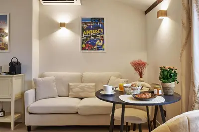 a white kitchen with a sink and a counter at Old Town Apartments By Villa Botanica in Cannes
