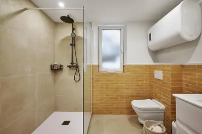 a bathroom sink with a mirror and a bottle of soap at Old Town Apartments By Villa Botanica in Cannes