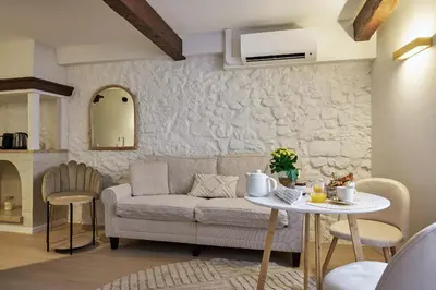 a living room with a couch and a table at Old Town Apartments By Villa Botanica in Cannes