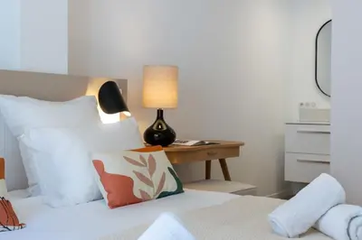 a bedroom with a bed with a lamp on a table at 2-Br Apartment Terrace Cannes City Centre in Cannes