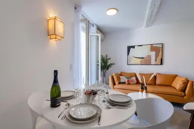 a living room with a white table and a couch at 2-Br Apartment Terrace Cannes City Centre in Cannes