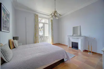a white bedroom with a bed and a fireplace at Lumineux 2 chambres, CARRE D'OR-COEUR DE CANNES A2B196 in Cannes