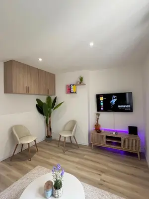a living room with a flat screen tv on a wall at Studio Vue Mer au coeur du Suquet in Cannes