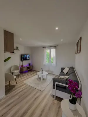 a living room with a couch and a table at Studio Vue Mer au coeur du Suquet in Cannes