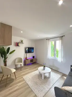 a living room with a couch and a table at Studio Vue Mer au coeur du Suquet in Cannes