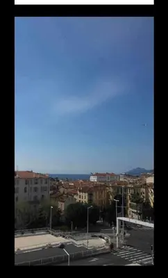 a view of a city with buildings and the ocean at Apartment Cosy Shared Center of Cannes in Cannes