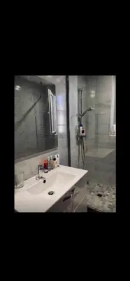 a bathroom with a sink and a mirror and a shower at Apartment Cosy Shared Center of Cannes in Cannes